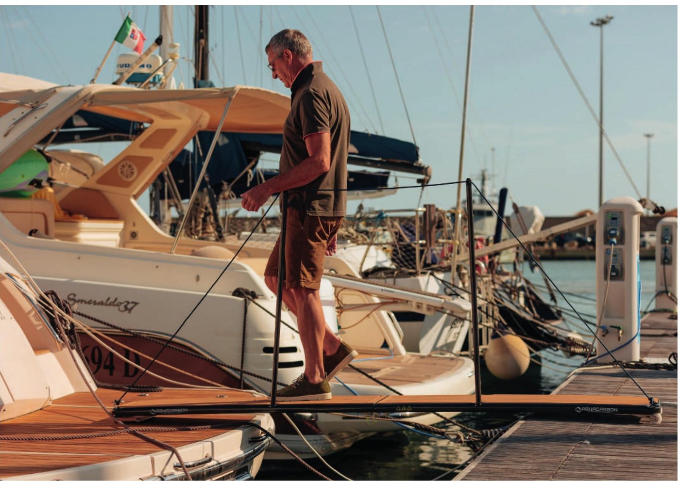 Man stepping ashore from his boat on an Aguacarbon EasyWay carbon fibre gangway